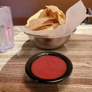 a bowl of chips and a bowl of salsa