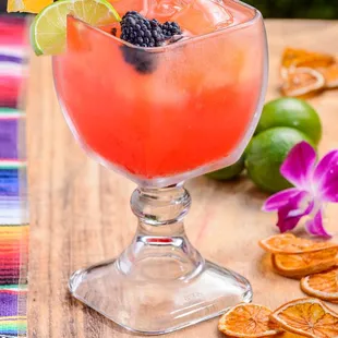 a close up of a drink with orange slices