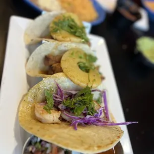 a long row of tacoss on a plate