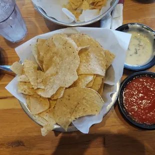 Chips salsa, hot salsa and white queso