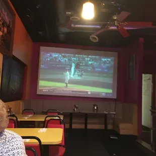 Big projection screen!  They usually show sports on SCREEN And TVs!