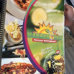 a hand holding a menu