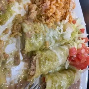 One beef, one cheese, one chicken enchilada with verde sauce &amp; rice &amp; beans.