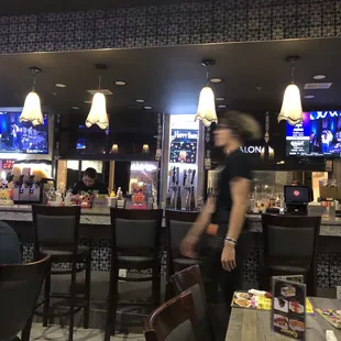 a woman walking by the bar