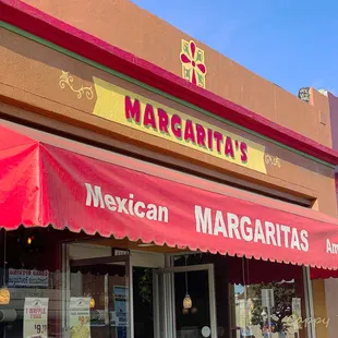 a mexican restaurant with a red awning