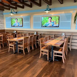 a dining area with wooden tables and chairs