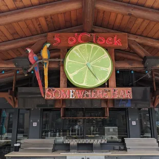 5 o'clock somewhere sign at outside bar.