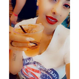 a woman holding a drink