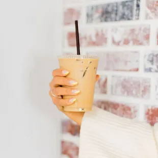 a woman holding a drink