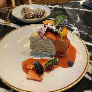 Fifteen layer crepe cake/ mini eclairs behind