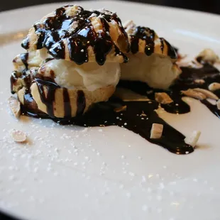 Profiteroles w/ vanilla bean ice cream, warm dark chocolate sauce, and toasted almonds