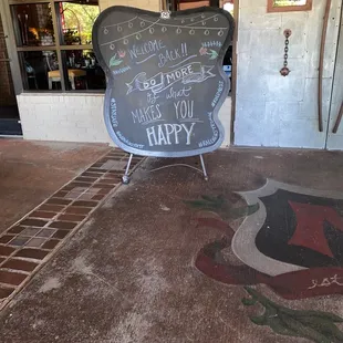 a chalkboard sign in front of a restaurant