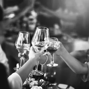 people toasting with wine glasses