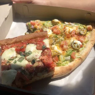 two slices of pizza in a box