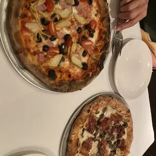 Ham, artichoke, and black olives and a white garlic sauce prosciutto and mushroom