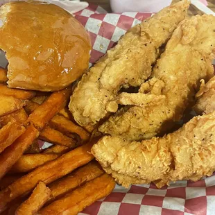 3 piece spicy tenders with sweet potato fries and a roll.