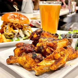 a plate of chicken wings and a glass of beer