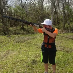 a man holding a shotgun