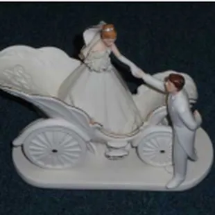 a figurine of a bride and groom in a carriage