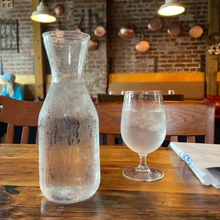 a pitcher and a glass of water