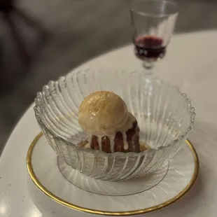 a dessert on a plate with a glass of wine