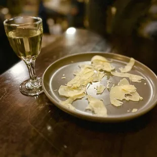 a plate of food and a glass of wine