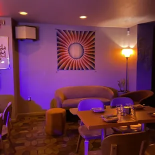 a dining room with purple lighting