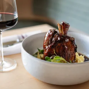 An entrée and glass of red wine