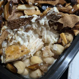 Tasekyeh with chicken - chicken, lemon, garbanzos, yogurt tahini topped with toasted pita & almonds