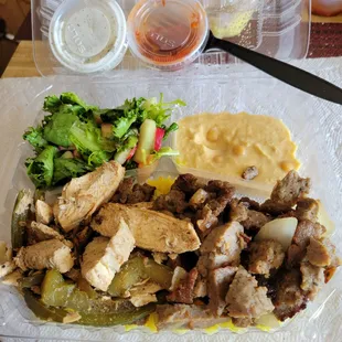 Chicken & Beef Combo plate, w/ a rice, salad,  hummus, and yogurt sauce. Really fresh and good!