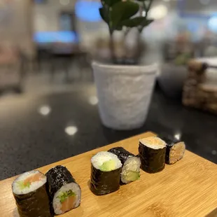 sushi rolls on a wooden board