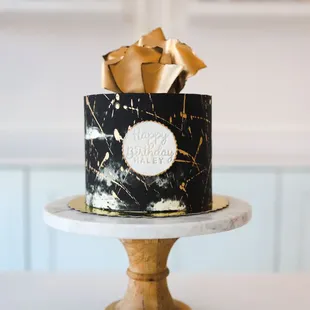 a black and gold marbled cake