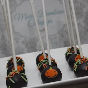 chocolate cake pops decorated with orange and green sprinkles