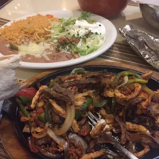 Fajitas with shrimp, chicken, steak, and chorizo.