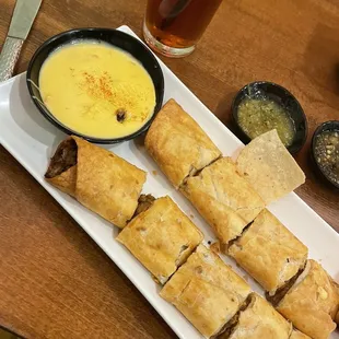 a plate of appetizers and dipping sauce
