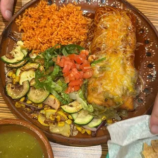 Beef chimichanga with red and green chile with calabasitas and rice