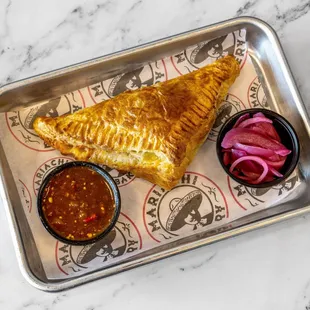 Empanada - Crafted with a soft buttery puff pastry and filled with your choice of savory filling and melted Monterey Jack cheese.