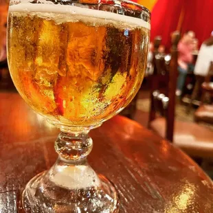 a glass of beer on a table