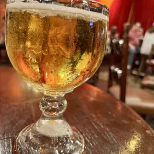 a glass of beer on a table
