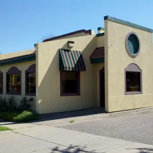 a yellow building with a green awning