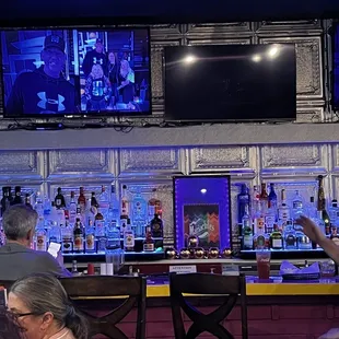 a bar with people sitting at the bar