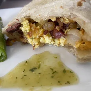 New breakfast burrito with their green salsa and grilled jalapeño. (Bacon is a bit hard) but still good.