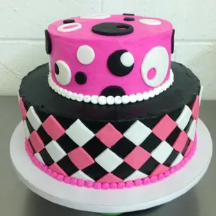 a pink and black polka dot cake