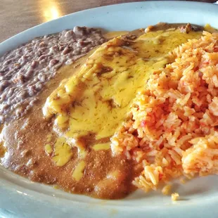 Other half of Deluxe Plate. Under that sea of cheese and gravy is a tamal and a cheese enchilada.