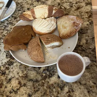 Mexican hot chocolate, conchas, dulce de leche empanada and a marranito.