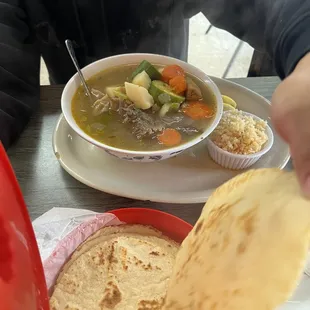 a person eating a bowl of soup