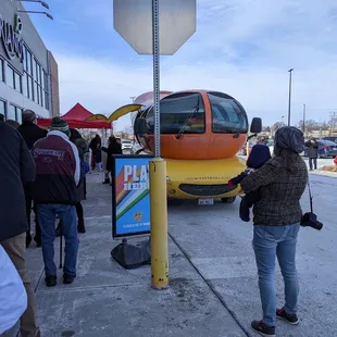 people waiting at a bus stop