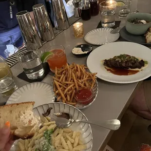 Mushroom pasta, fries, and a steak.