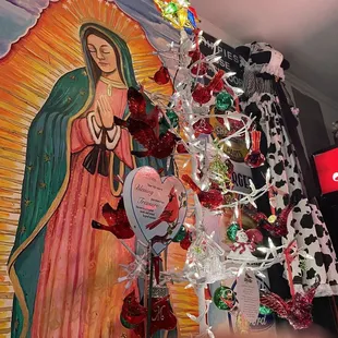 the virgin of guadalupe surrounded by decorations