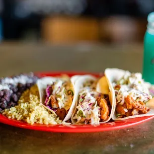 a plate of mexican food and a drink